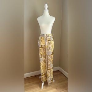 Luxurious DREW silky flare pant. Barocco pattern. Pockets and elastic waistband.